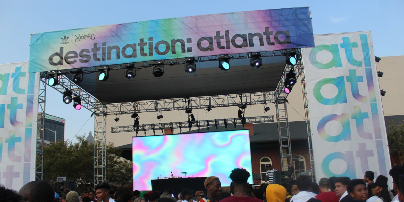 Georgia Freight Depot during Destination Atlanta with stage, crows, and VIP area in scene