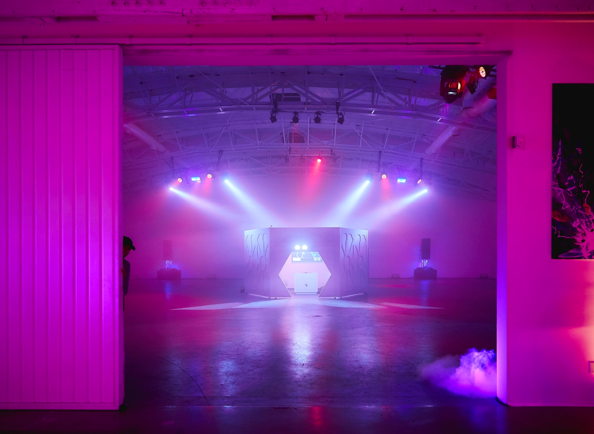 Wide view of the Goodbye Gravity event space featuring a central interactive installation and dramatic lighting.