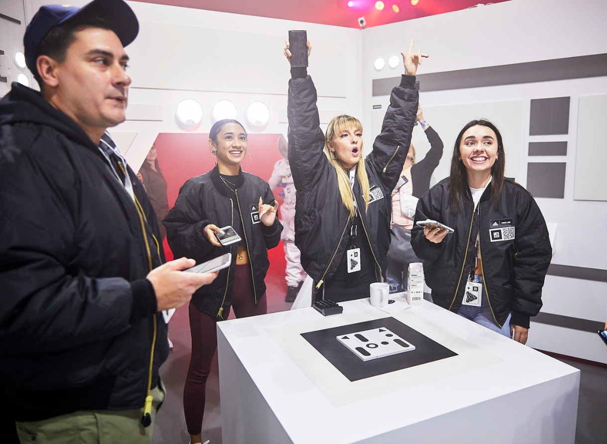 Guests cheer and celebrate during an interactive moment at the Goodbye Gravity event.