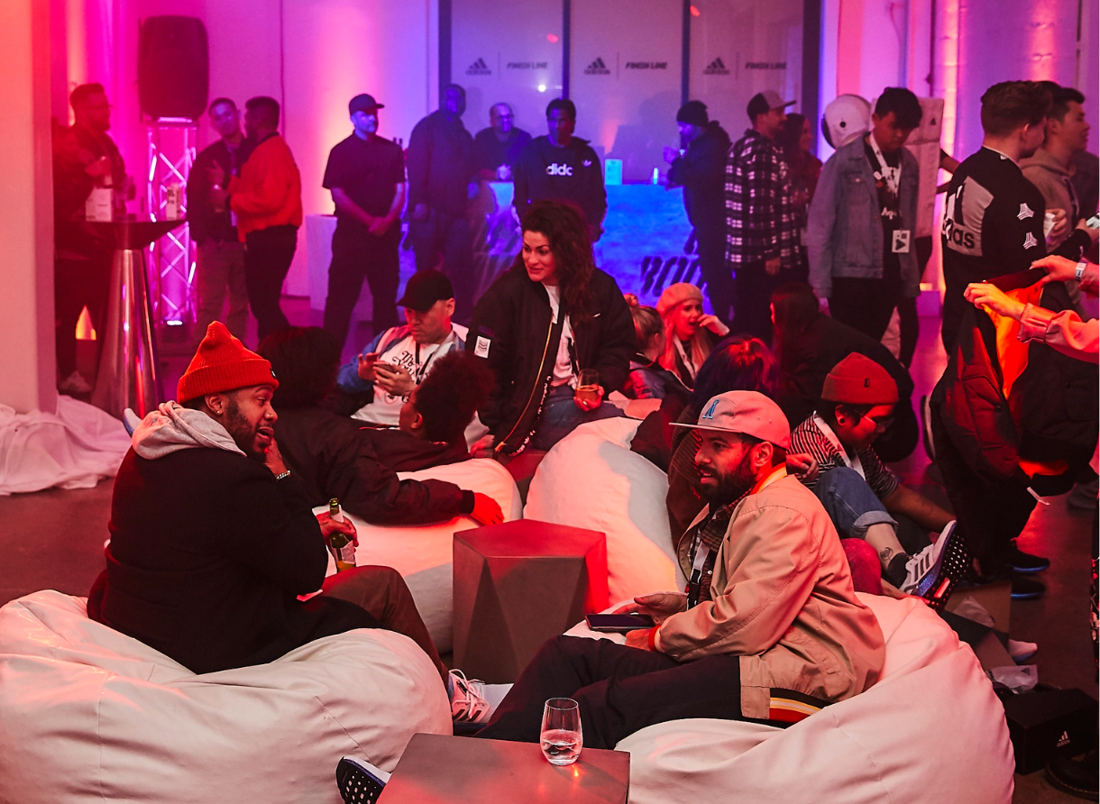 Guests relax and socialize in a lounge area at the Goodbye Gravity adidas and Finish Line event.