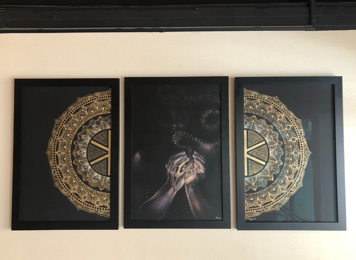 Triptych wall art with gold mandala designs and symbolic imagery inside Kove Yoga studio.